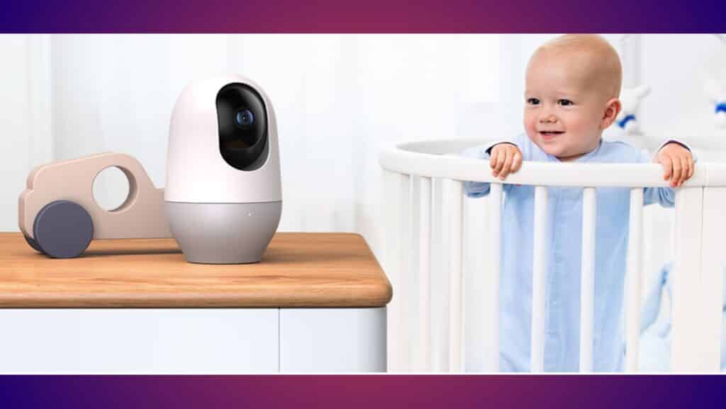 baby in crib smiling looking at baby monitor